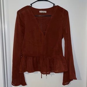 Rust colored long sleeve flare blouse. US size small